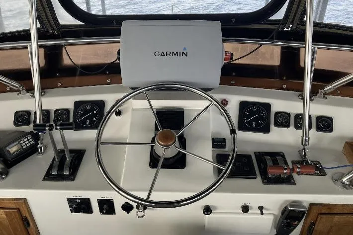 Slide: The Image of Boat cockpit with Garmin navigation, steering wheel, and control panels. - 9