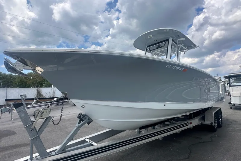 The Image of 2019 Sea Hunt Ultra 275 SE boat on trailer under cloudy sky. - 0