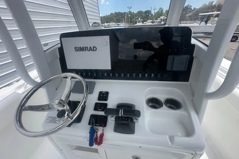 Slide: The Image of 2019 Sea Hunt Ultra 275 SE boat dashboard with Simrad display and steering wheel. - 5