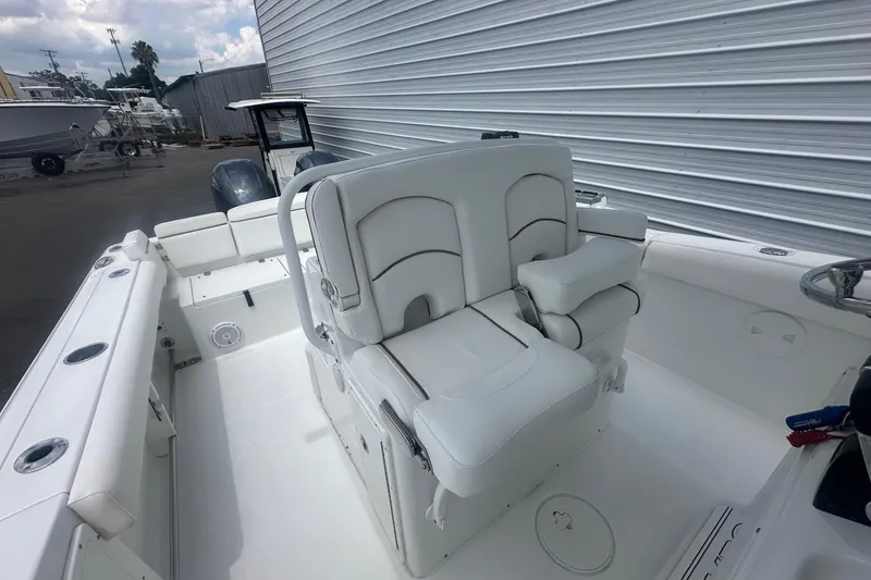 Slide: The Image of 2019 Sea Hunt Ultra 275 SE boat interior with white seating and steering wheel. - 7