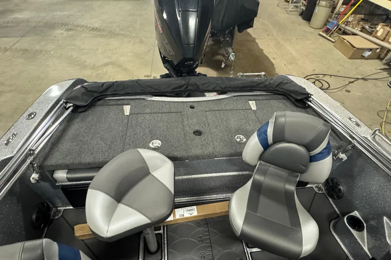 Slide: The Image of 2026 Nitro ZV19 Sport Pro boat interior with gray and blue seating, and rear motor view. - 10