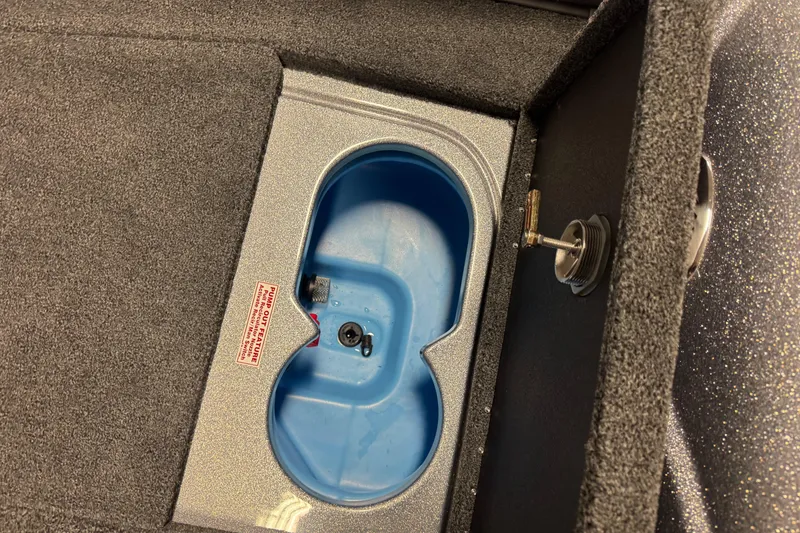 Slide: The Image of 2026 Nitro ZV19 Sport Pro boat compartment with blue interior and key lock mechanism. - 16