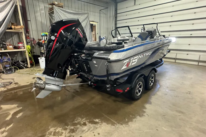 Slide: The Image of 2026 Nitro ZV19 Sport Pro boat in a garage, featuring a powerful outboard motor. - 3
