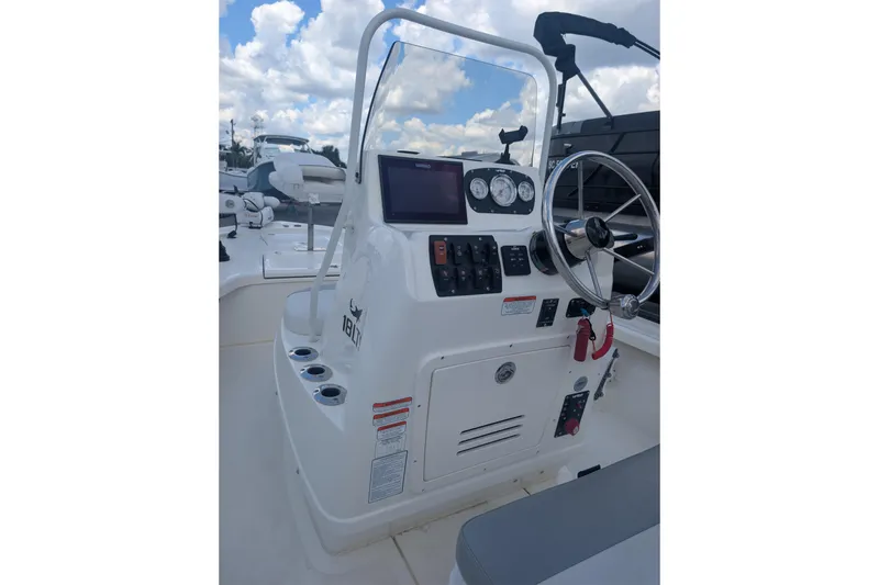 Slide: The Image of 2024 Mako 18 LTS boat console with steering wheel and control panel. - 4