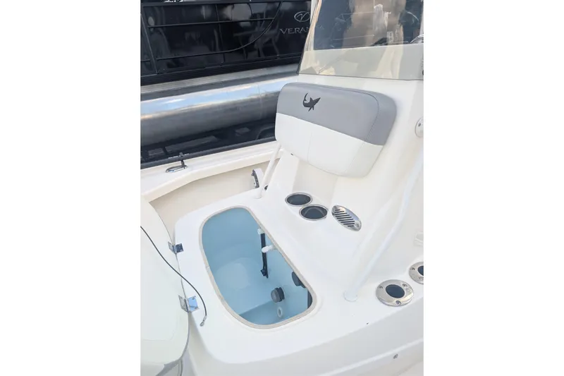 Slide: The Image of 2024 Mako 18 LTS boat interior with open storage compartment and seating. - 5