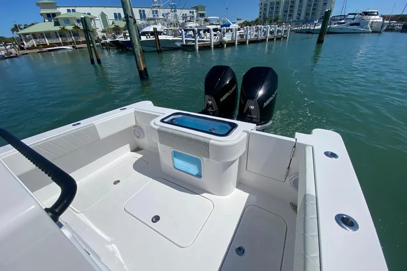 Slide: The Image of 2026 Reef Runner 280 boat with dual Mercury engines docked at marina. - 10