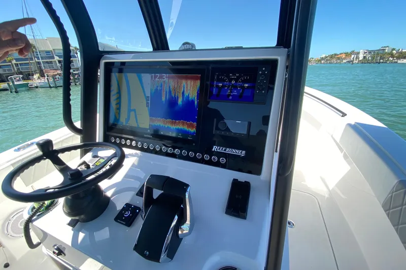 Slide: The Image of 2026 Reef Runner 280 boat dashboard with navigation and control systems. - 12