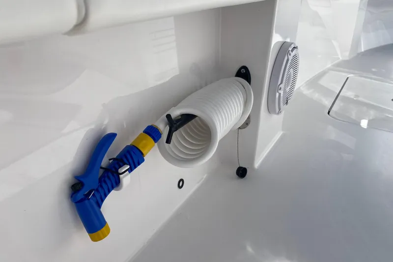 Slide: The Image of Coiled hose and nozzle on 2026 Reef Runner 280 boat deck. - 16