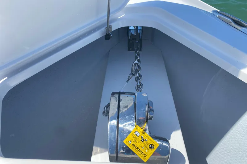Slide: The Image of Anchor chain compartment of 2026 Reef Runner 280 boat with warning label. - 23