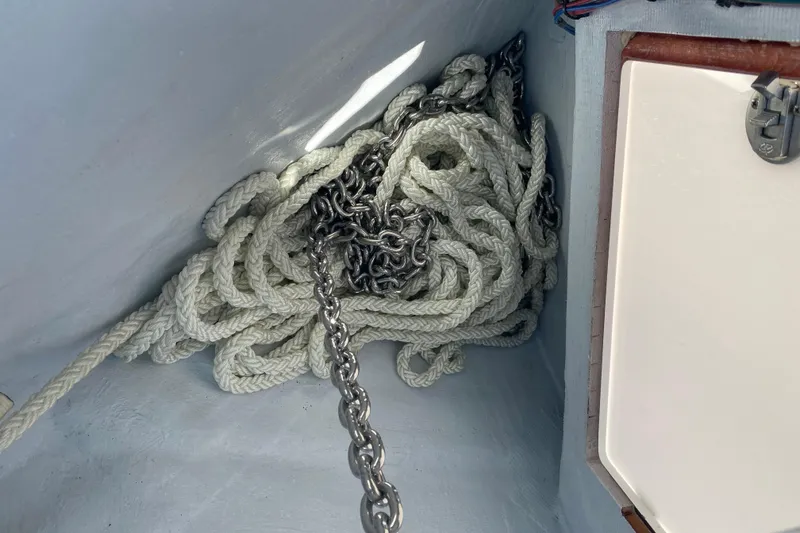 Slide: The Image of Coiled rope and chain in a 2026 Reef Runner 280 boat compartment. - 24