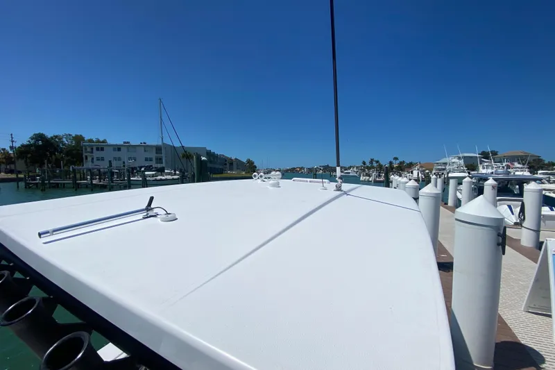 Slide: The Image of 2026 Reef Runner 280 boat docked at marina under clear blue sky. - 26