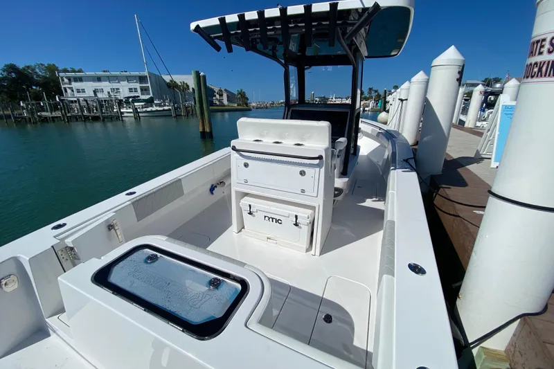 Slide: The Image of 2026 Reef Runner 280 boat docked at marina, showcasing spacious deck and modern design. - 4