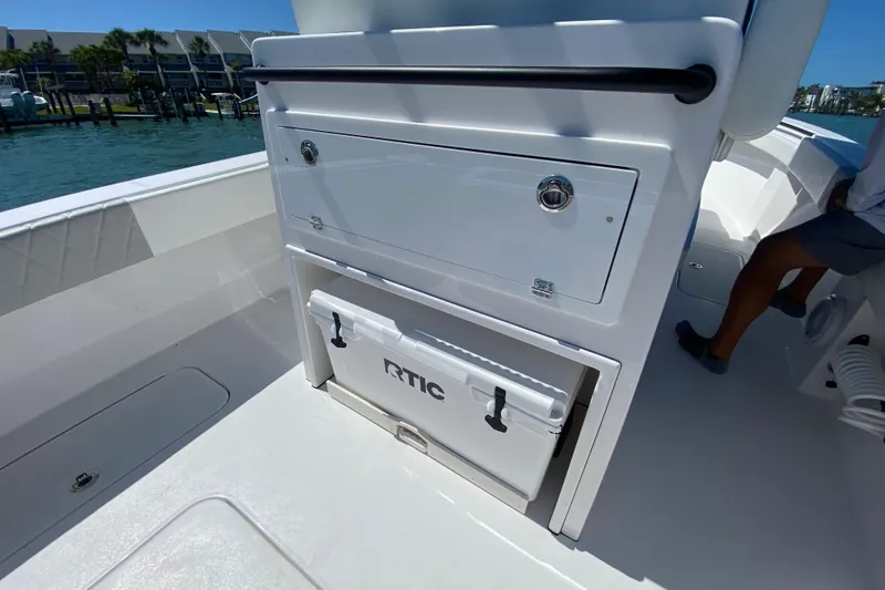 Slide: The Image of 2026 Reef Runner 280 boat interior with storage compartment and cooler on deck. - 8