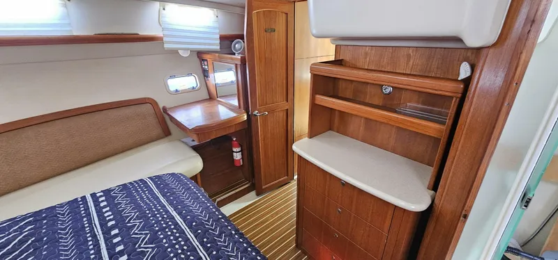 Slide: The Image of Interior of a 2007 Hunter 45 Center Cockpit yacht with wooden cabinetry and cozy seating. - 13