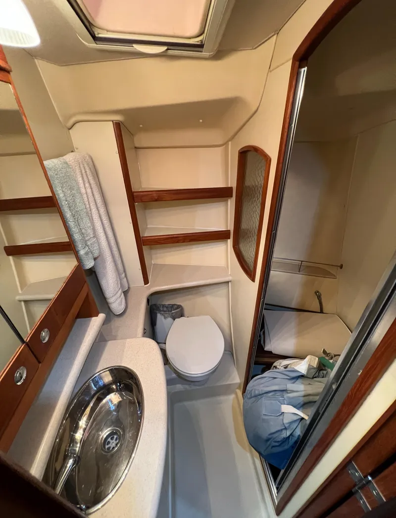 Slide: The Image of 2007 Hunter 45 Center Cockpit bathroom with sink, toilet, and shower area. - 14