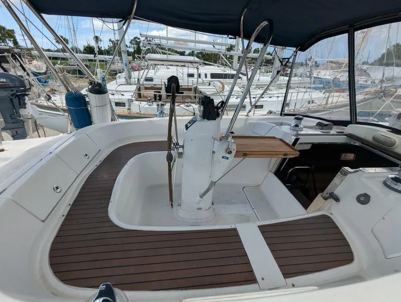 Slide: The Image of 2007 Hunter 45 Center Cockpit sailboat with spacious helm and wooden deck accents. - 18
