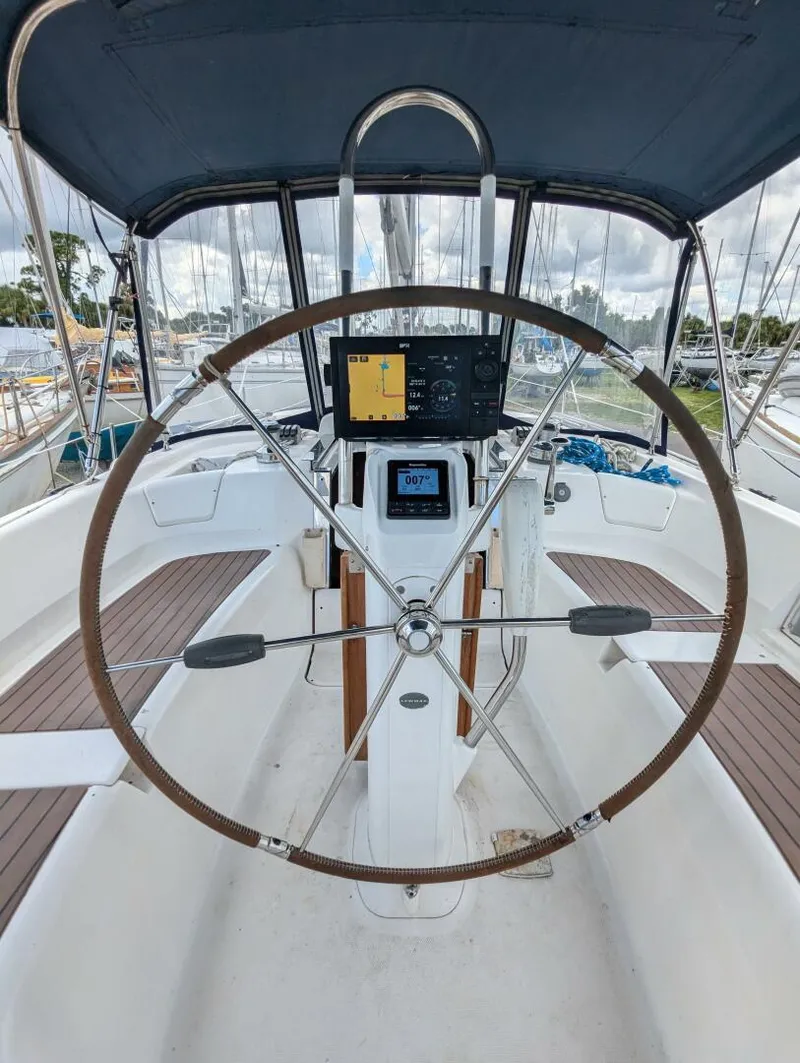 Slide: The Image of 2007 Hunter 45 Center Cockpit with navigation equipment and steering wheel, docked at marina. - 19