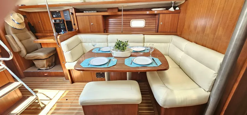 Slide: The Image of Luxurious 2007 Hunter 45 Center Cockpit interior with elegant dining area and plush seating. - 3