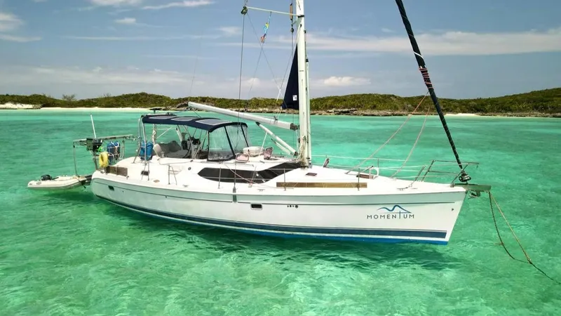 Slide: The Image of Sailboat "Hunter 45 Center Cockpit" 2007 anchored in clear blue water near lush green hills. - 33
