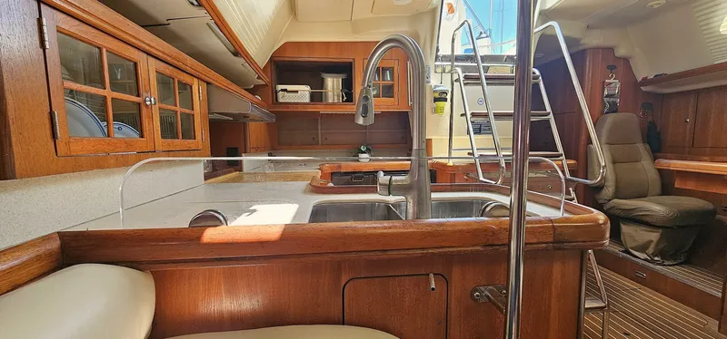 Slide: The Image of Interior of 2007 Hunter 45 Center Cockpit yacht with wooden cabinetry and modern kitchen amenities. - 6