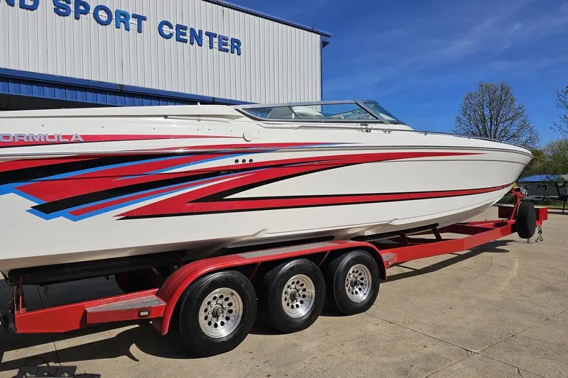 Slide: The Image of 2001 Formula 382 FASTech boat on red trailer at sport center. - 10