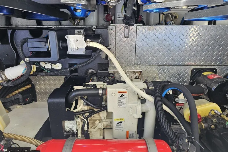 Slide: The Image of Engine compartment of a 2001 Formula 382 FASTech boat, showcasing mechanical components and wiring. - 103