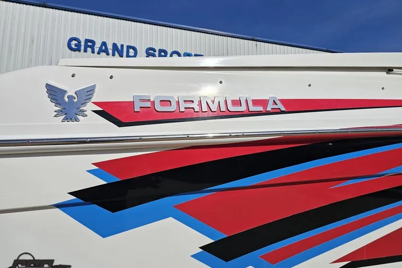 Slide: The Image of 2001 Formula 382 FASTech boat with vibrant red, blue, and black graphics. - 12