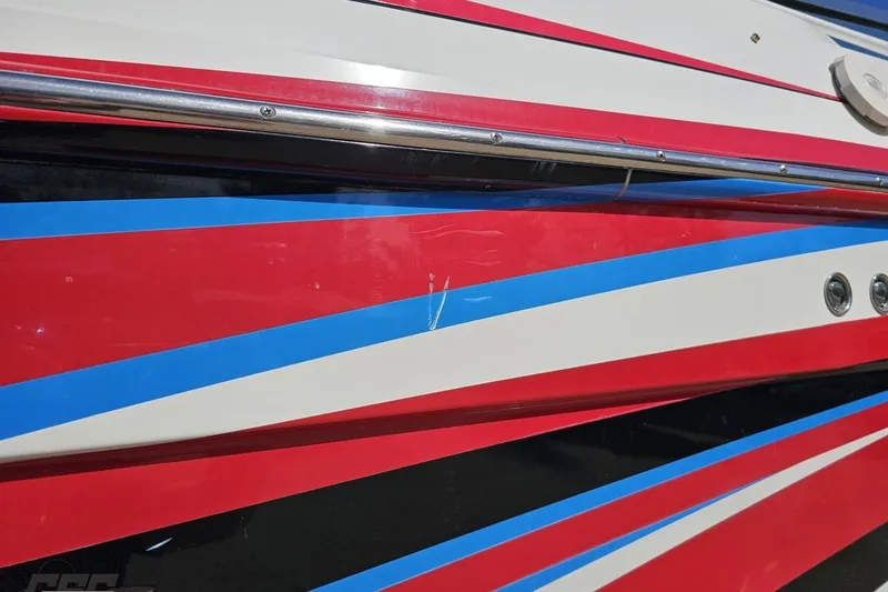 Slide: The Image of 2001 Formula 382 FASTech boat with vibrant red, blue, and white stripes. - 13