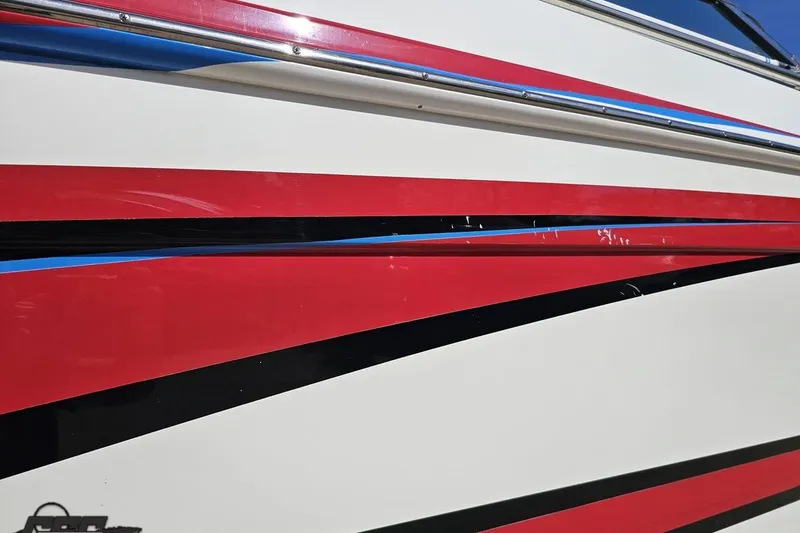 Slide: The Image of 2001 Formula 382 FASTech boat with red, black, and blue stripes on the hull. - 14