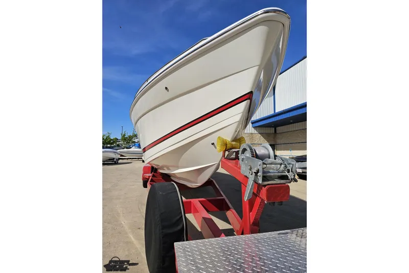 Slide: The Image of 2001 Formula 382 FASTech boat on red trailer under clear blue sky. - 19