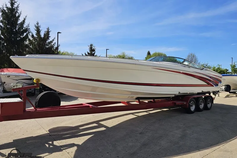 Slide: The Image of 2001 Formula 382 FASTech boat on trailer, parked outdoors under clear blue sky. - 20