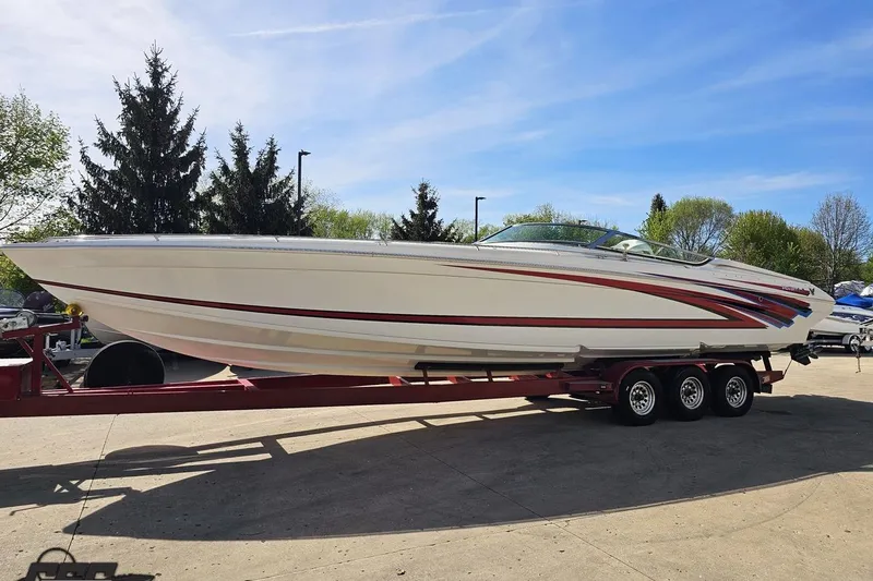 Slide: The Image of 2001 Formula 382 FASTech boat on a trailer, parked outdoors under a clear blue sky. - 21