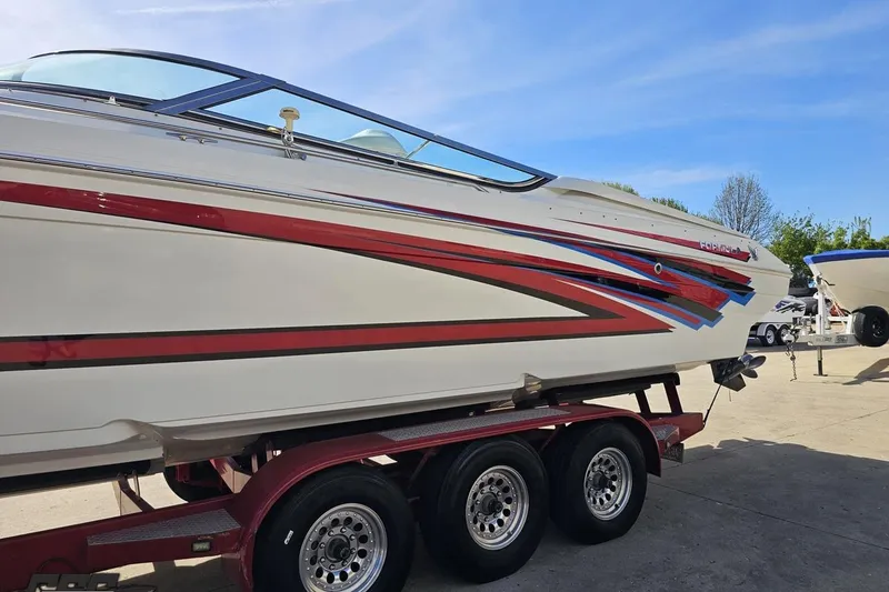 Slide: The Image of 2001 Formula 382 FASTech boat on trailer, featuring sleek red and blue graphics. - 23