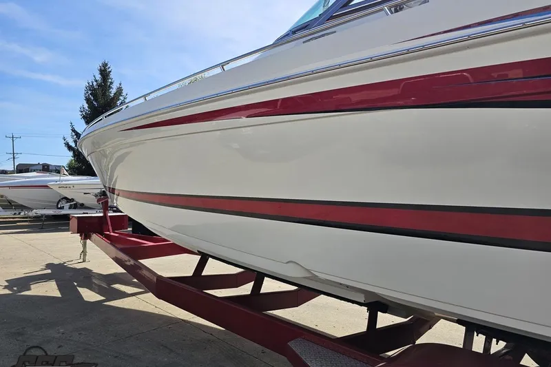 Slide: The Image of 2001 Formula 382 FASTech boat on trailer, featuring sleek red and white design. - 25