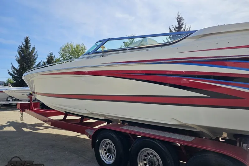 Slide: The Image of 2001 Formula 382 FASTech boat on trailer, featuring sleek red and blue accents. - 26