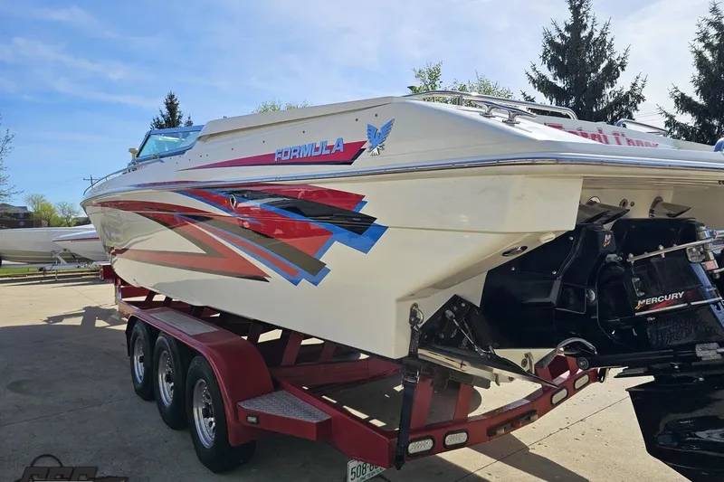 Slide: The Image of 2001 Formula 382 FASTech boat on trailer, featuring vibrant graphics and Mercury engine. - 29
