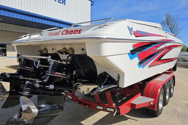 Slide: The Image of 2001 Formula 382 FASTech boat on trailer, featuring vibrant red and blue graphics. - 33
