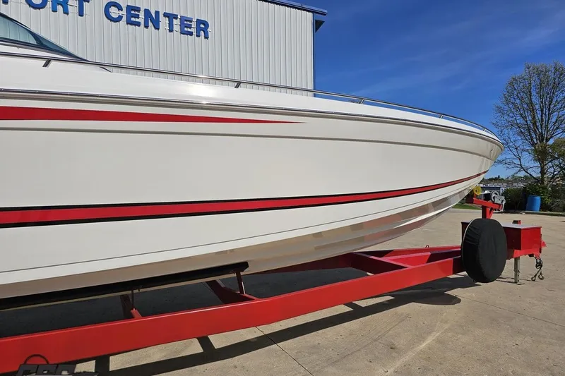 Slide: The Image of 2001 Formula 382 FASTech boat on red trailer at a transport center. - 5