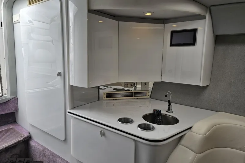 Slide: The Image of Interior of a 2001 Formula 382 FASTech boat with sleek white cabinetry and compact sink. - 55