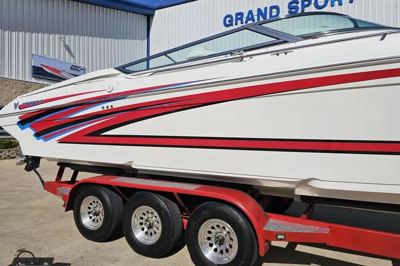 Slide: The Image of 2001 Formula 382 FASTech boat on red trailer, featuring sleek red and blue graphics. - 6