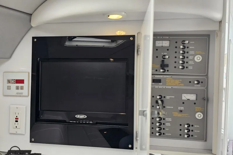 Slide: The Image of Control panel and monitor inside a 2001 Formula 382 FASTech boat cabin. - 64