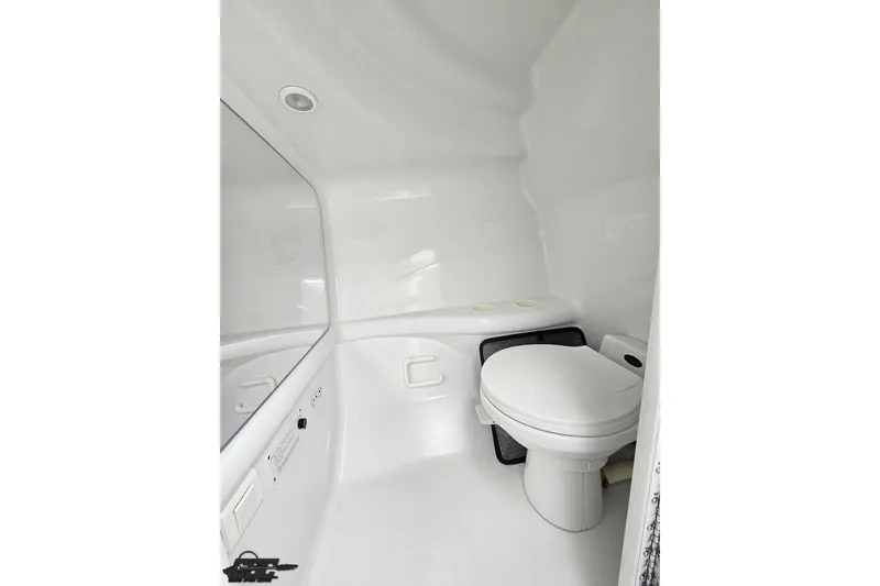 Slide: The Image of 2001 Formula 382 FASTech boat bathroom with white interior and compact toilet. - 65