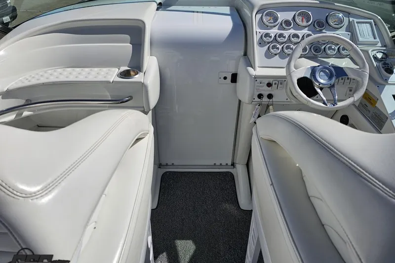 Slide: The Image of Interior of a 2001 Formula 382 FASTech boat with white seating and dashboard controls. - 67