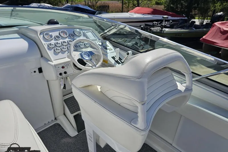 Slide: The Image of 2001 Formula 382 FASTech boat cockpit with white leather seating and control panel. - 68