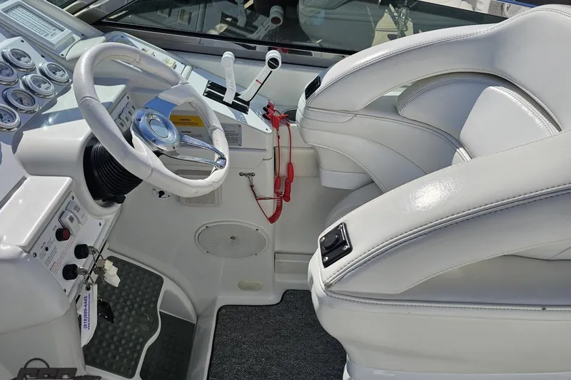 Slide: The Image of Interior of a 2001 Formula 382 FASTech boat with white leather seating and control panel. - 69