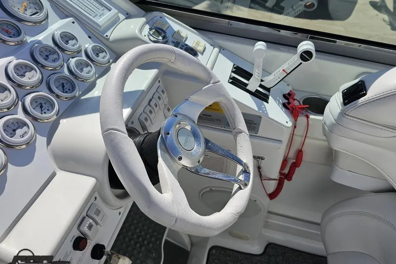 Slide: The Image of Cockpit of a 2001 Formula 382 FASTech boat with steering wheel and gauges. - 70