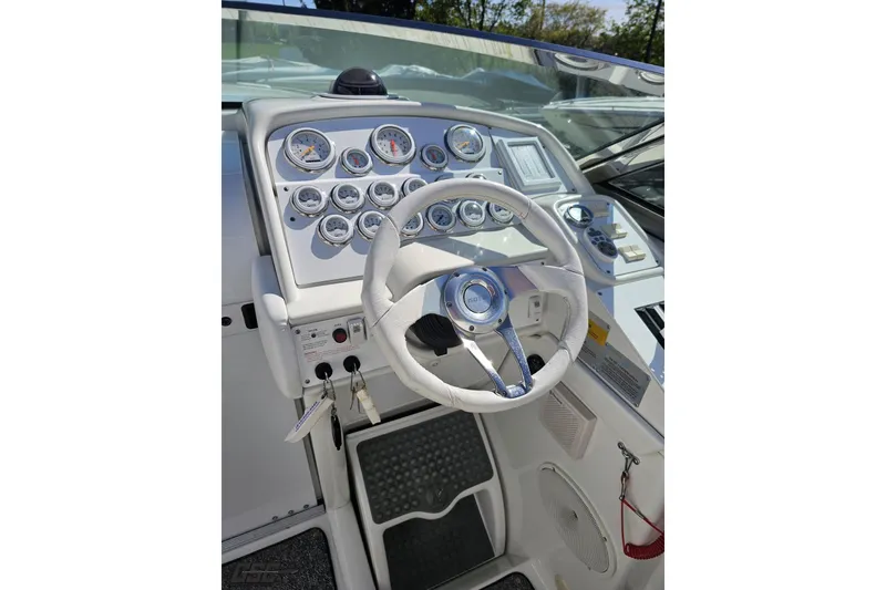 Slide: The Image of 2001 Formula 382 FASTech boat dashboard with steering wheel and gauges. - 71