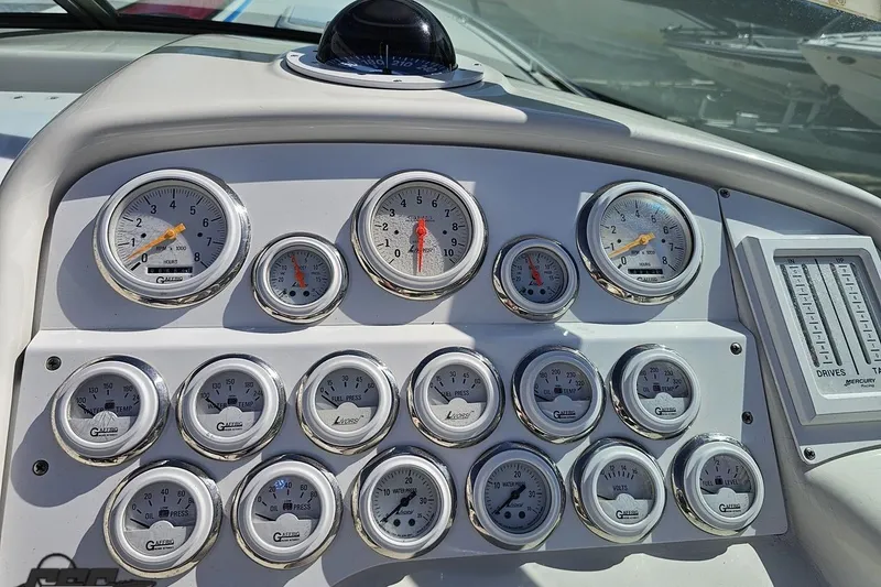 Slide: The Image of Dashboard of a 2001 Formula 382 FASTech boat with multiple gauges and controls. - 73