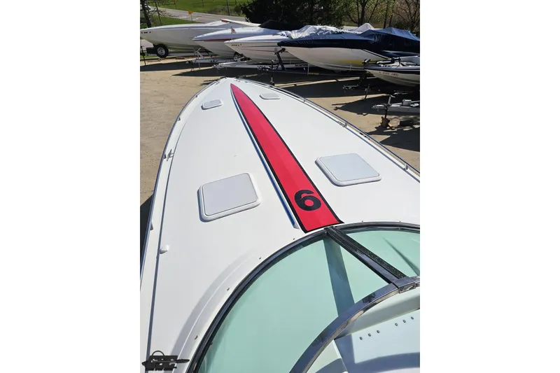 Slide: The Image of 2001 Formula 382 FASTech boat with red stripe and number six on deck. - 74