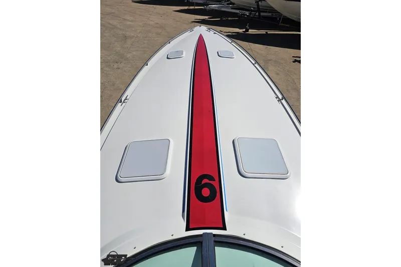Slide: The Image of 2001 Formula 382 FASTech boat with red stripe and number six on deck. - 75